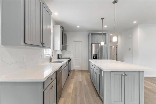 a kitchen with a sink stove and cabinets