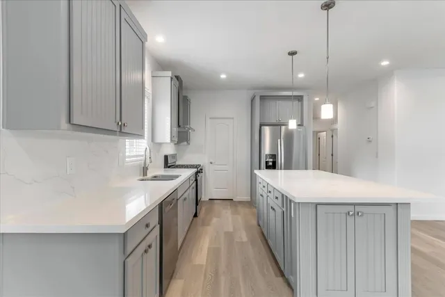 a kitchen with a sink stove and cabinets