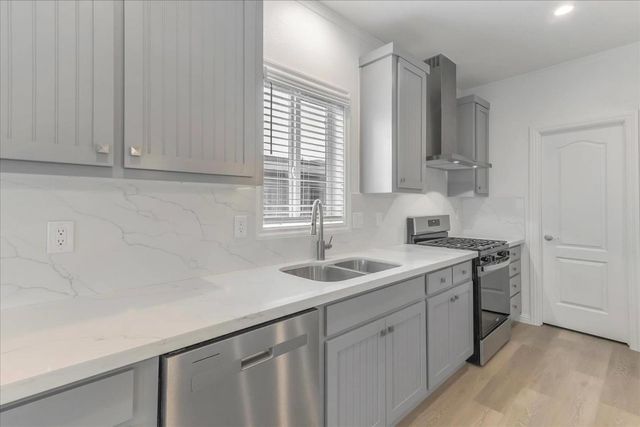 a kitchen with a sink cabinets and window