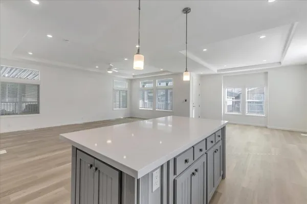 a kitchen with kitchen island a sink appliances and a counter space