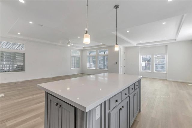 a kitchen with kitchen island a sink appliances and a counter space