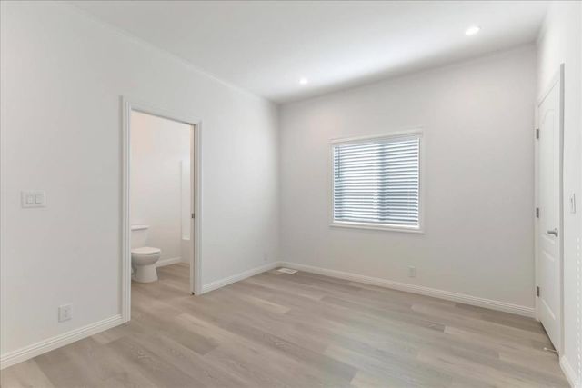 an empty room with a entryway and a toilet