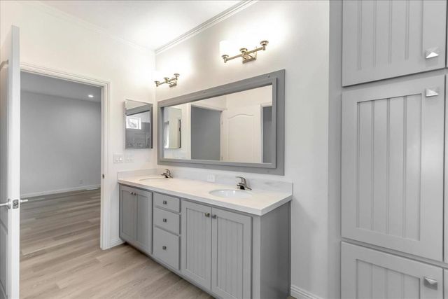a spacious bathroom with a double vanity sink and a mirror