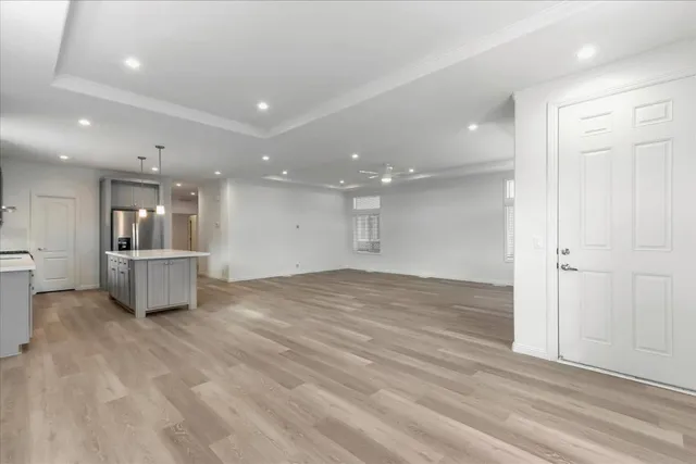 a view of a kitchen with a sink and a refrigerator