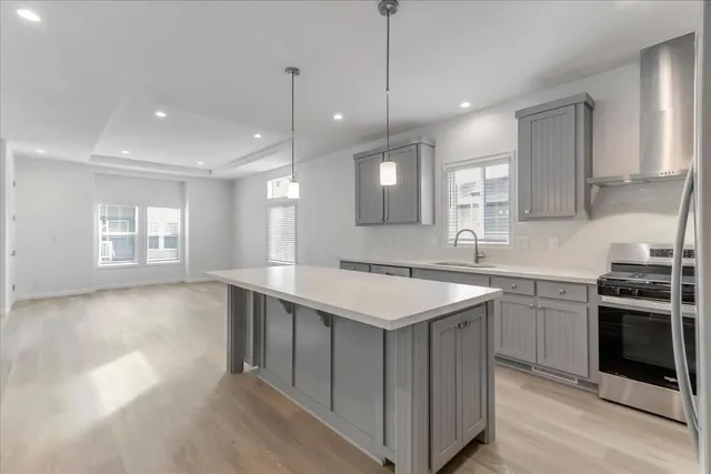 a kitchen with a sink stove and microwave