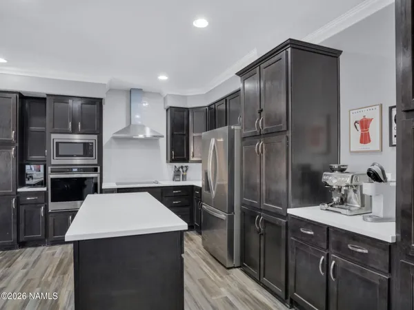 a kitchen with a refrigerator sink and wooden cabinets