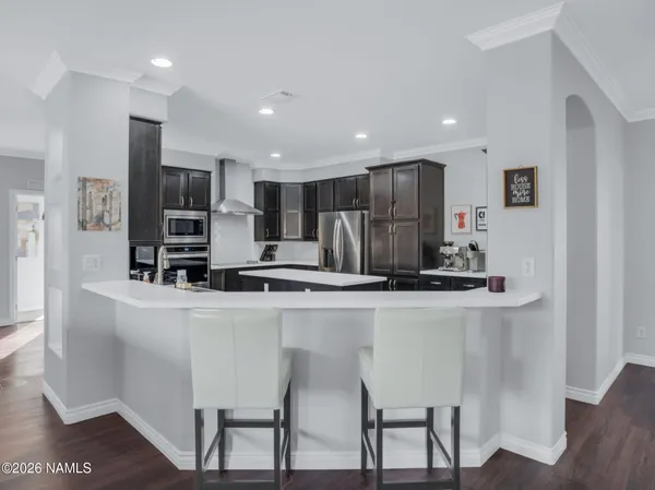 a kitchen with stainless steel appliances a refrigerator and a stove top oven