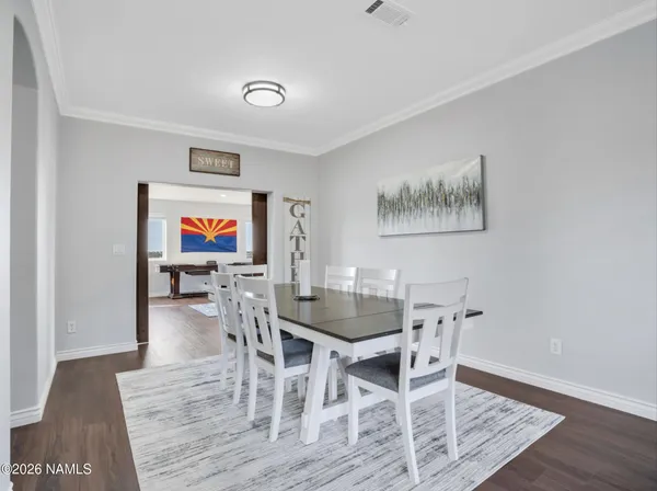 a view of a dining room with furniture and wooden floor