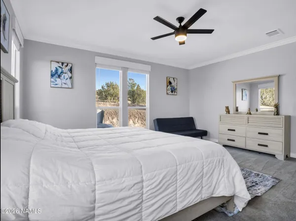 a bedroom with a bed and a large window