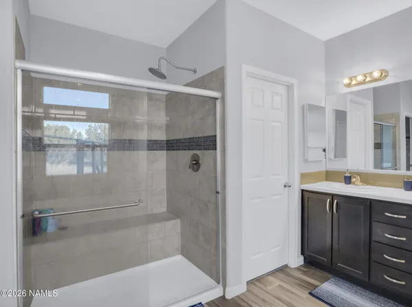 a bathroom with a tub sink and mirror