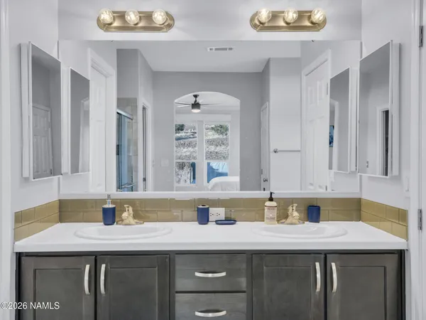 a kitchen with a sink a cabinets and wooden floor