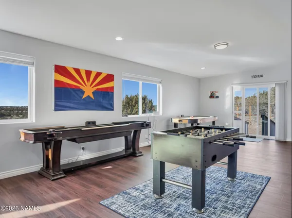 a living room with furniture a rug and a painting on the wall