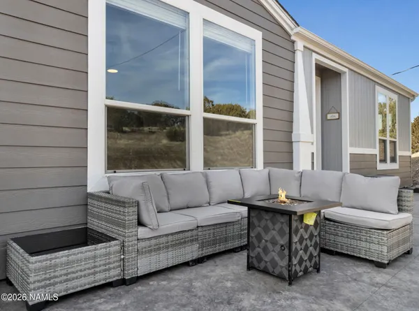a patio with patio couch and glass door