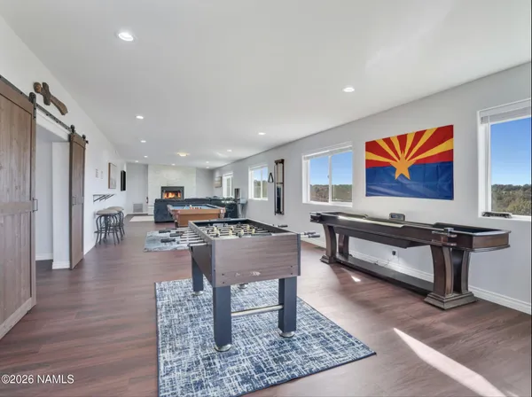 a living room with furniture a rug and a painting