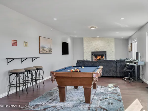 a living room with furniture a flat screen tv and a fireplace