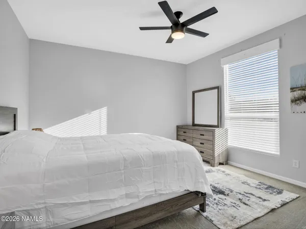 a bedroom with a large bed and a window