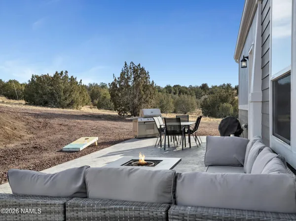 a terrace with outdoor seating and trees