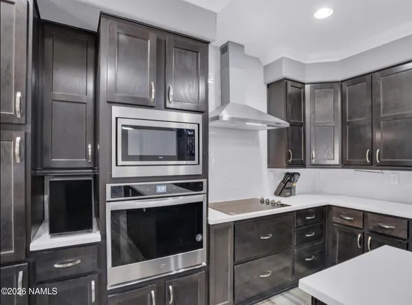 a kitchen with granite countertop stainless steel appliances and wooden cabinets