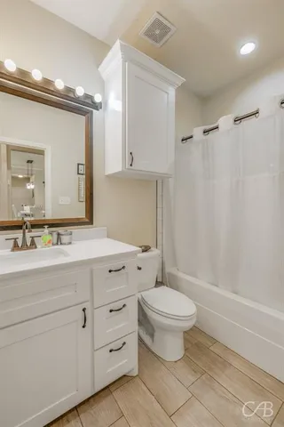 a view of bedroom with furniture and chandelier fan
