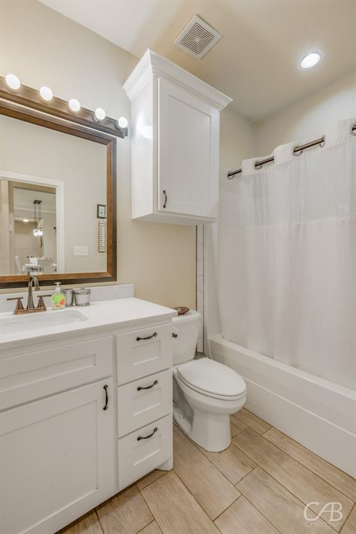 625 Jarrell Court Tuscola, TX 79562 - Photo 17 of 32 a bathroom with a granite countertop sink a toilet and a mirror