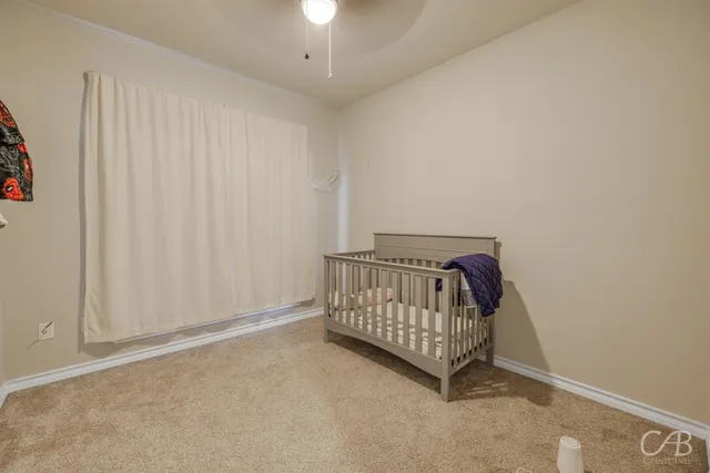 a view of a bedroom with wooden floor