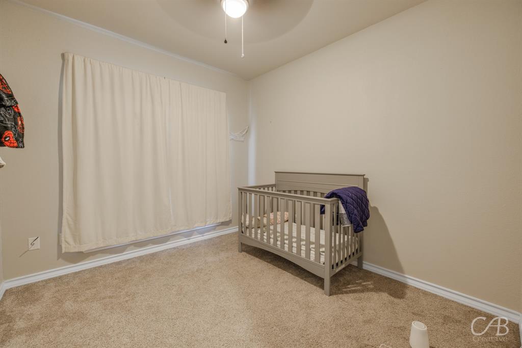 625 Jarrell Court Tuscola, TX 79562 - Photo 18 of 32 a view of bedroom with furniture and chandelier fan