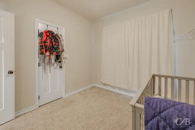 a bedroom with a bed and a chair