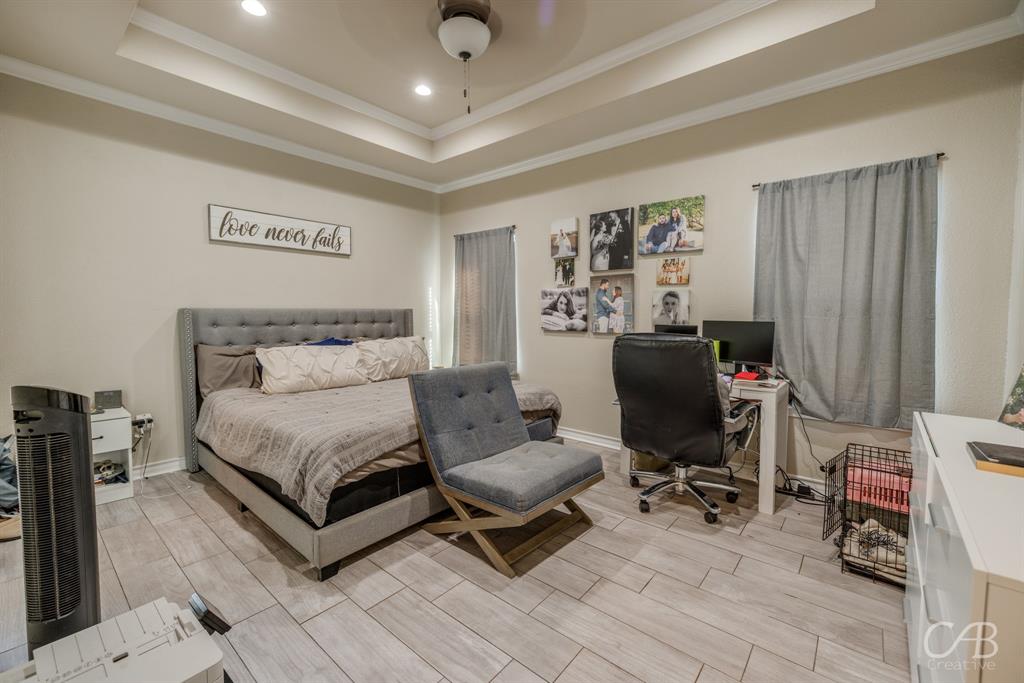 625 Jarrell Court Tuscola, TX 79562 - Photo 23 of 32 a bedroom with a bed and a chair