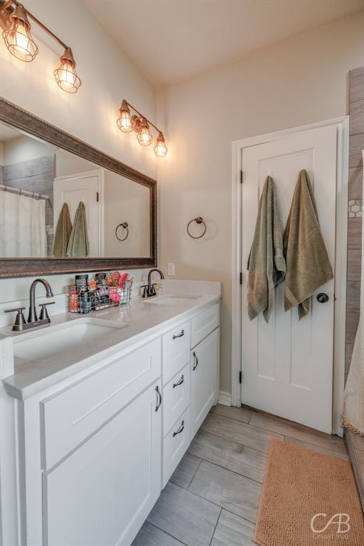 625 Jarrell Court Tuscola, TX 79562 - Photo 26 of 32 a bathroom with a sink and a mirror