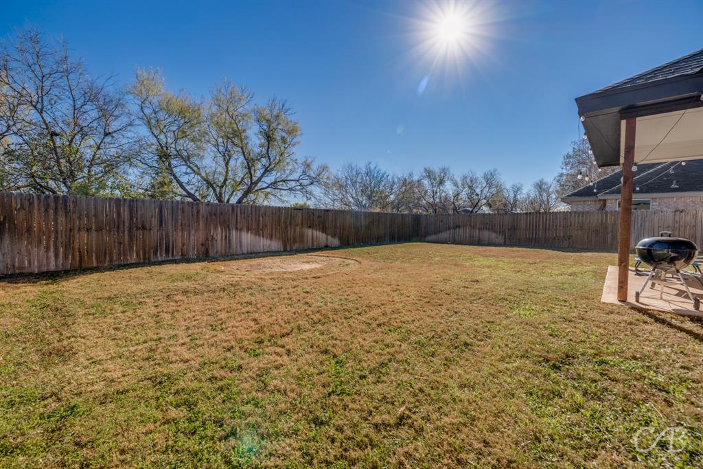 625 Jarrell Court Tuscola, TX 79562 - Photo 30 of 32 a bathroom with a tub and trees in the background