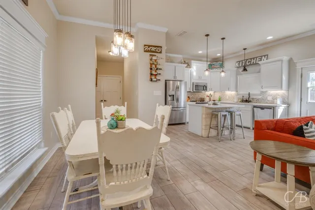 a view of a dining room with furniture and chandelier
