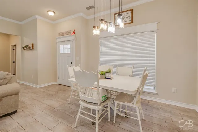 a view of a dining room with furniture and chandelier
