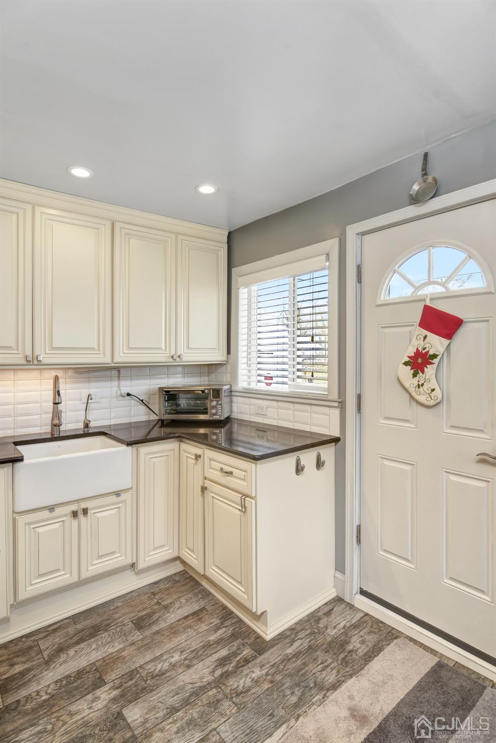 24 Racetrack Road East Brunswick, NJ 08816 - Photo 16 of 37 a kitchen with stainless steel appliances granite countertop a sink and cabinets with wooden floor