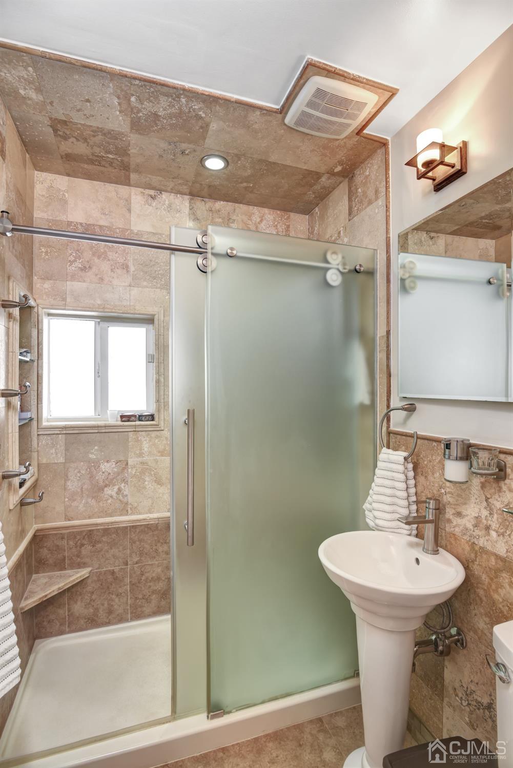 24 Racetrack Road East Brunswick, NJ 08816 - Photo 19 of 37 a bathroom with a sink mirror and a shower