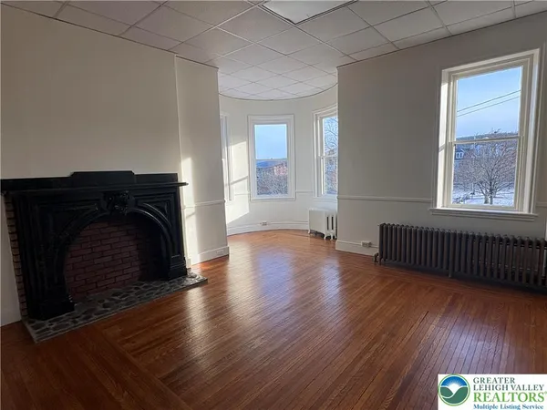 a kitchen with a refrigerator a stove a microwave and wooden floor