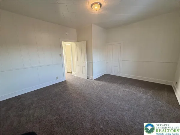 a view of a hallway to rooms