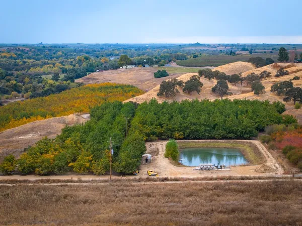 an aerial view of a house with pool lake view and mountain view