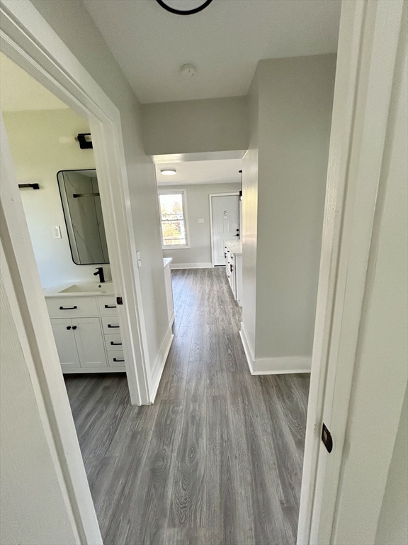 16 North Street West Springfield, MA 01089 - Photo 14 of 28 a view of a hallway to a livingroom with wooden floor and furniture