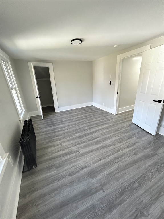 16 North Street West Springfield, MA 01089 - Photo 19 of 28 wooden floor in an empty room with a window