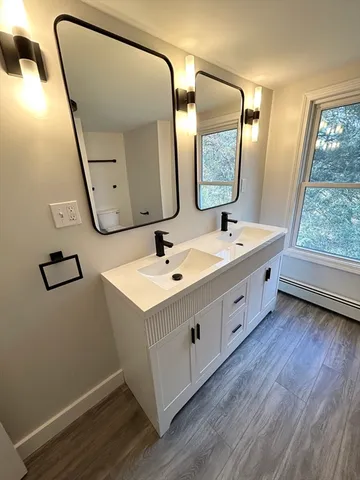 a spacious bathroom with a double vanity sink and a mirror