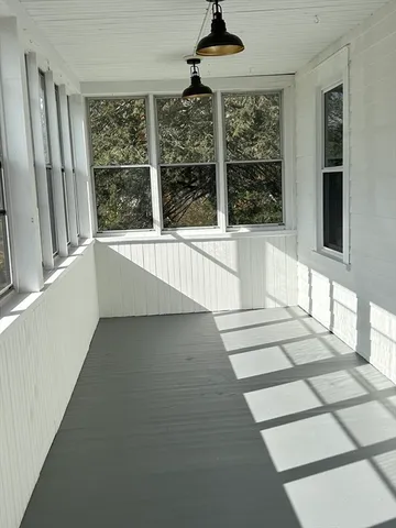 a view of a kitchen with granite countertop a refrigerator a sink and windows