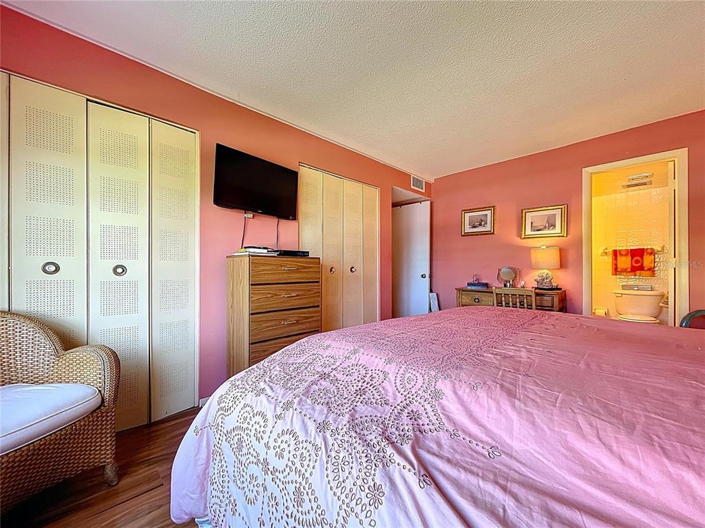 4650 Cove Circle, Unit 209 St. Petersburg, FL 33708 - Photo 12 of 54 a bedroom with a bed and a television