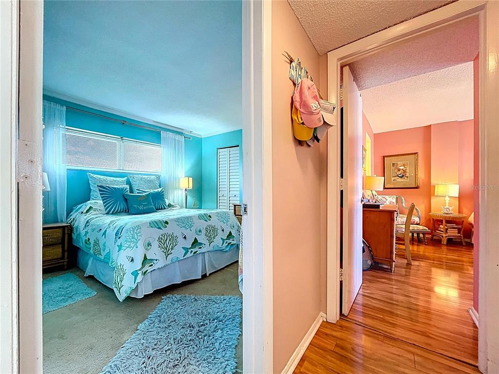 4650 Cove Circle, Unit 209 St. Petersburg, FL 33708 - Photo 15 of 54 a bedroom with a bed and a table