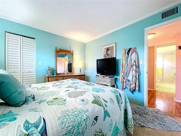 a bedroom with a bed and a flat screen tv