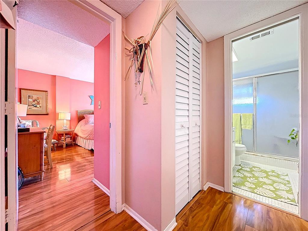4650 Cove Circle, Unit 209 St. Petersburg, FL 33708 - Photo 18 of 54 a view of a bedroom and wooden floor