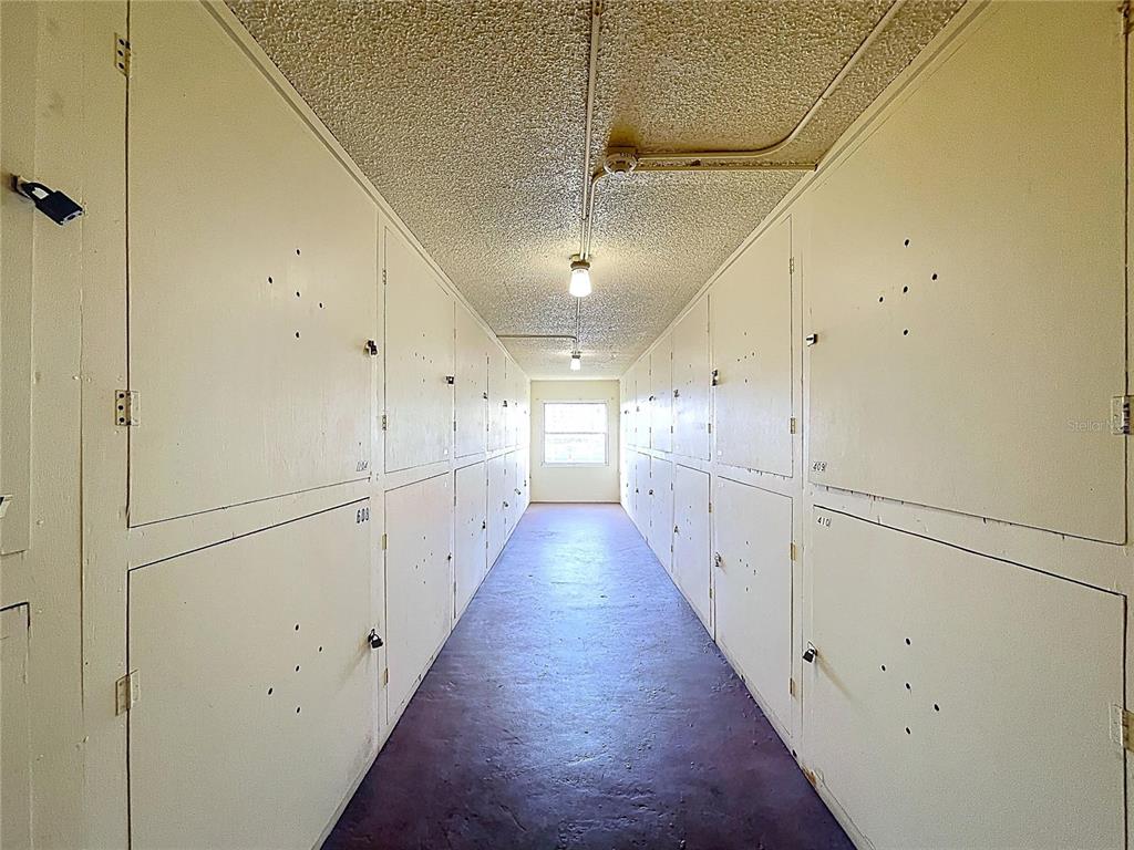 4650 Cove Circle, Unit 209 St. Petersburg, FL 33708 - Photo 21 of 54 a view of a hallway with wooden floor