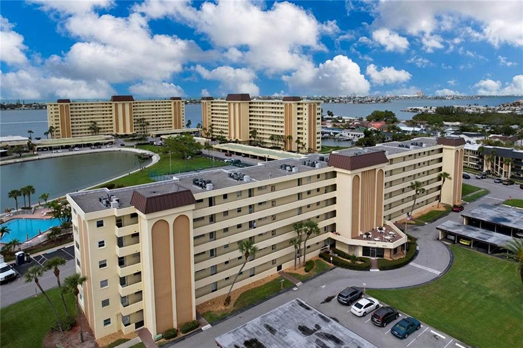 4650 Cove Circle, Unit 209 St. Petersburg, FL 33708 - Photo 28 of 54 a view of a lake with a yard