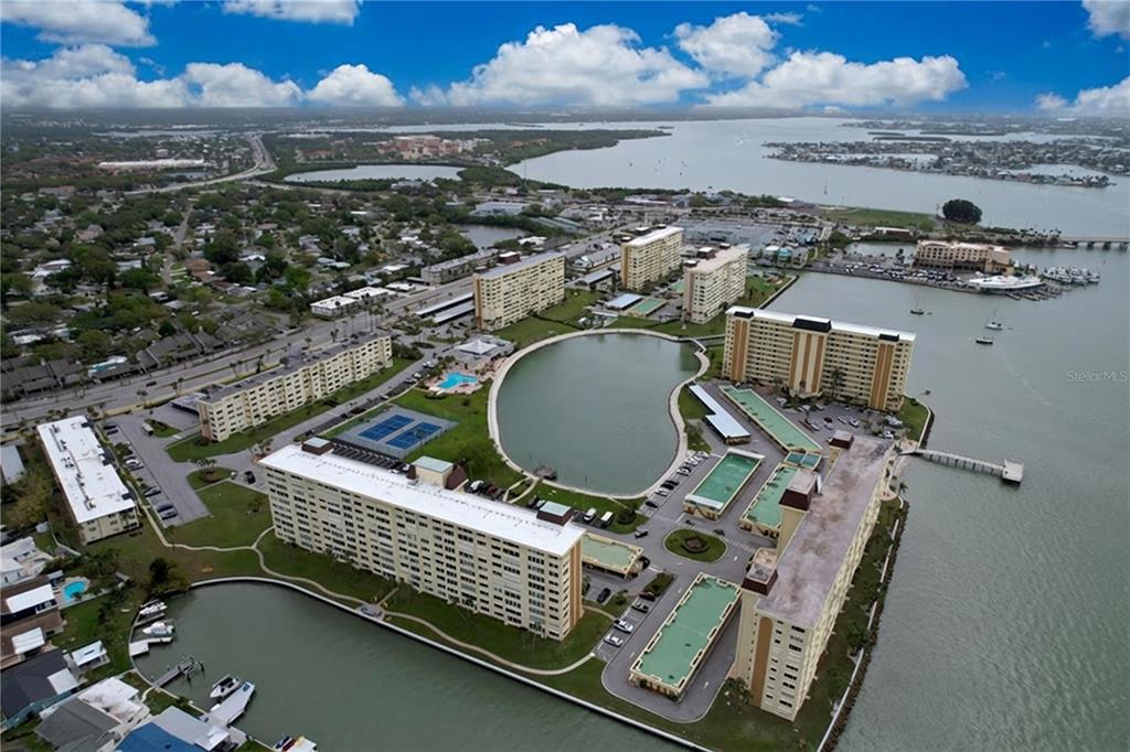 4650 Cove Circle, Unit 209 St. Petersburg, FL 33708 - Photo 35 of 54 an aerial view of a chairs and table on the terrace