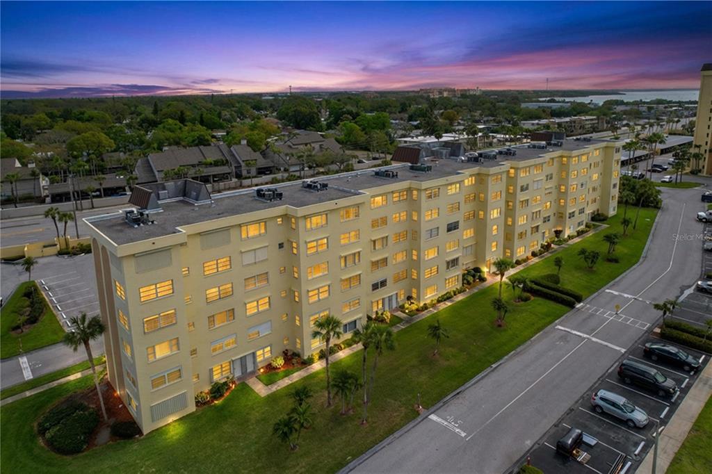 4650 Cove Circle, Unit 209 St. Petersburg, FL 33708 - Photo 47 of 54 a view of a swimming pool with a yard