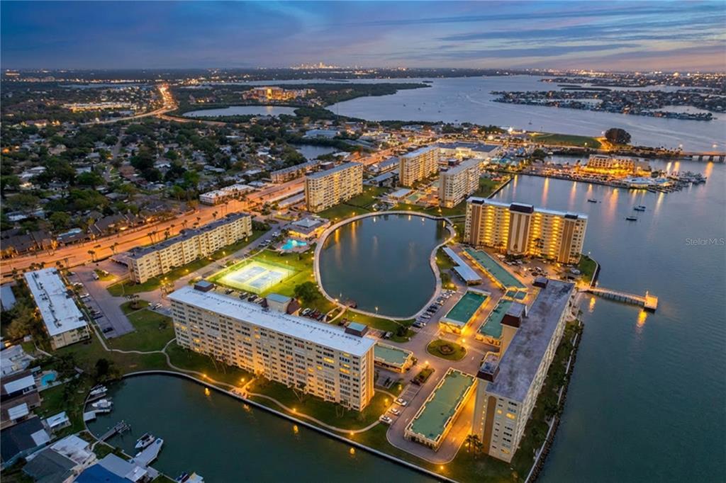 4650 Cove Circle, Unit 209 St. Petersburg, FL 33708 - Photo 50 of 54 an aerial view of residential houses with outdoor space